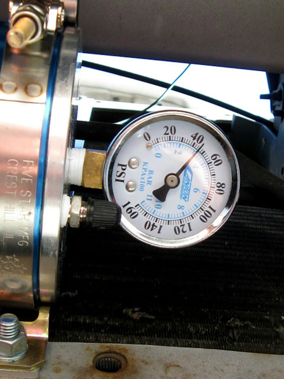 IMG_3188 Powering up the ignition opens the valve, and once the engine is running, oil begins to fill the reservoir, raising the air pressure on the far side of the piston to approximately the same level as the engine oil pressure. Turn the ignition off, and the valve closes, trapping pressurized oil ready for the next cold start.