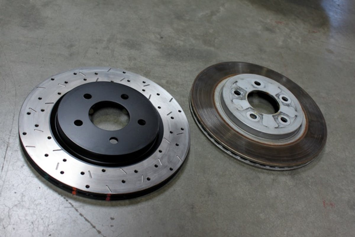 IMG_0275 Out back, 4000-Series XS rotors are the upgrade of choice. Look closely at the rim of the new rotor and you'll notice DBA's thermo-graphic paint markings. Also featured on the 5000-Series, these marks change color permanently at 856 (green stripe) 1022 (orange stripe) and 1166 (red stripe) degrees F to let you know what temperature range your brakes are achieving.