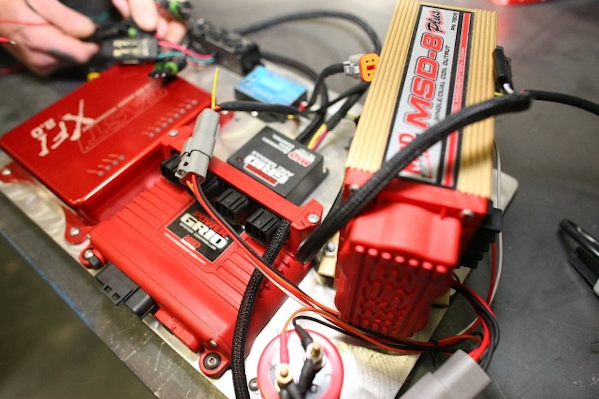 Shown here are the electronics for BlownZ mounted on a plate that we can install and remove as one from the passenger side of the car. You can see here the MSD ignition system, the XFI 2.0, and the Davis Drag Pro MAP unit up in the top left of the photo.