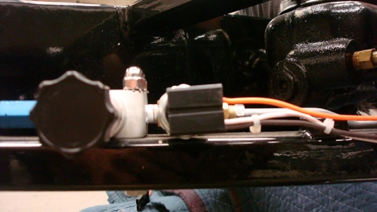 The system ties into the brake-pressure switch in order to prevent accidental starting. You must have your foot firmly on the pedal while you press the button to activate the circuit.