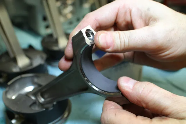 Groh snaps the Clevite Boss 302 replacement rod bearings into place - these came highly recommended to us by none other than Justin Burcham, who works closely with RGR Engines to design his company's championship-winning powerplants.