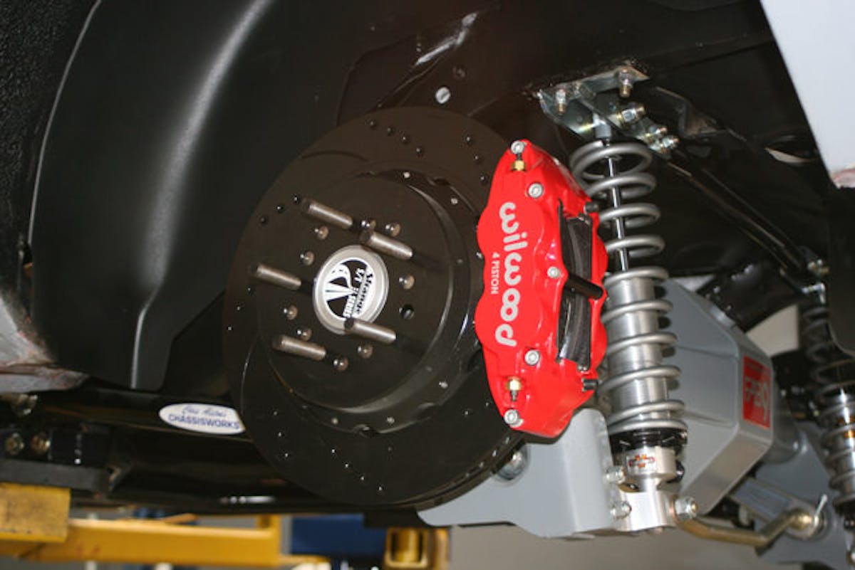 We used Wilwood's four-piston caliper for this application. Use as many shims as needed for proper alignment when adjusting caliper offset; and always use the same number of shims on the top and bottom caliper mounting bolts.