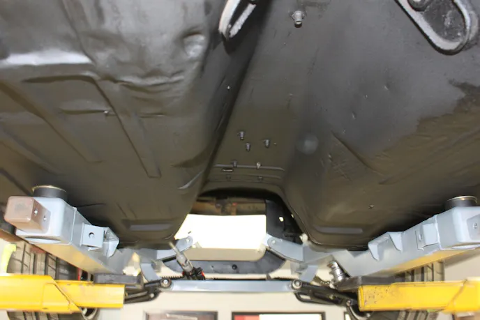 Once the stock rearend was removed and the mini-tub kit installed, we took a few minutes to clean and paint the car's underside.