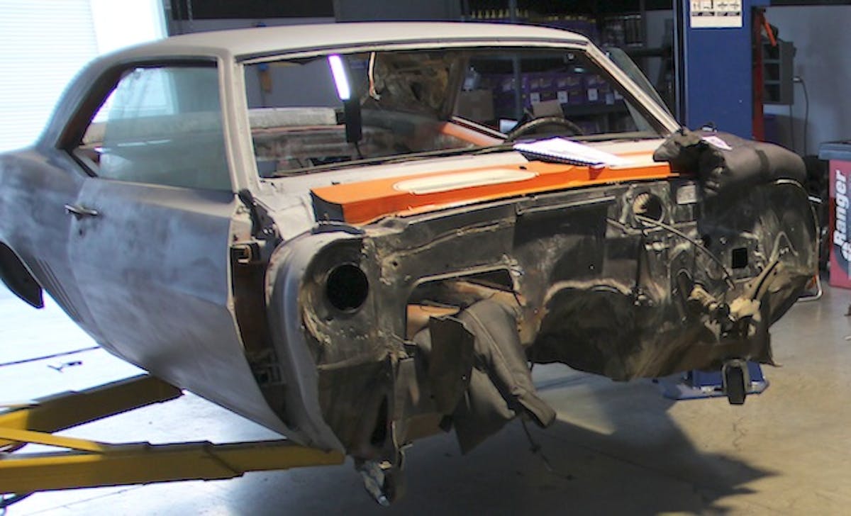 We began by removing all the original components and the factory front clip. Because ours was a project car that someone else started but didn't finish, we didn't have to worry about many of the components. In very short order we were left with a bare firewall.