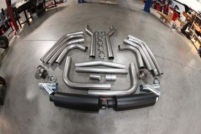 Shown here is the entire gamut of components we're going to be working with on our exhaust install on the '65, including the Flowmaster U-Fit 3-inch exhaust tubing and Pro Series mufflers, Pertronix electronic cutouts, Y-pipes, Bullet resonators, and a pair of flex joints, along with all of the associated hardware.