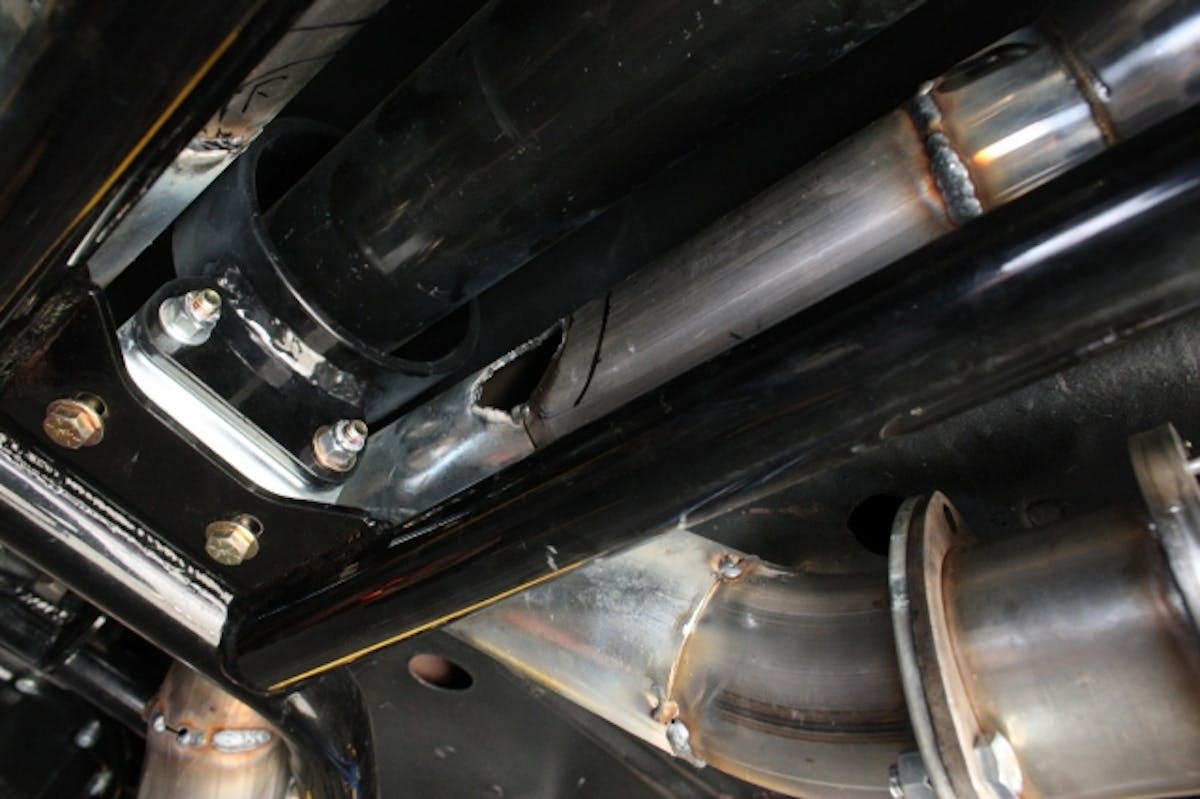 Here, you can  see the hole that we've cut in the pipes to weld the H-pipe into.