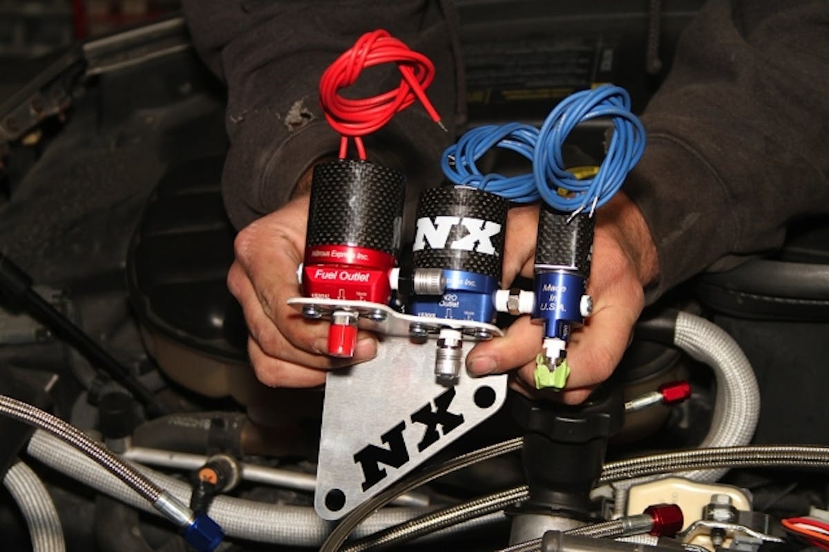 Nitrous Express provided this gorgeous laser cut bracket to attach the solenoids to the cylinder head. You can see the smaller blue purge solenoid connected directly to the port on the main nitrous solenoid.