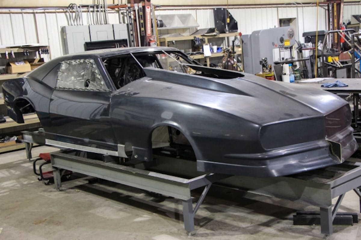 With the front end, doors and body all mounted, it's time to pull the engine back out and move towards the rear of the car.