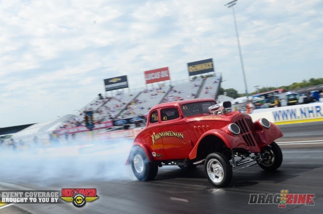 How do you get an instant reaction from the crowd here at Indy? Boil the hides clear to the 1/8-mile mark...that's how. Several of the Gasser racers, whose performance includes crew in tribal outfits and Backup Girls in go-go boots, are letting their classic machines eat all for the entertainment of the fans.