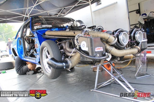 Mark Micke and Jason Carter make some adjustments to the suspension to better work with the hot track this afternoon in the second session of Outlaw Drag Radial qualifying, Micke currently sits ninth with a 4.62 @178 MPH.