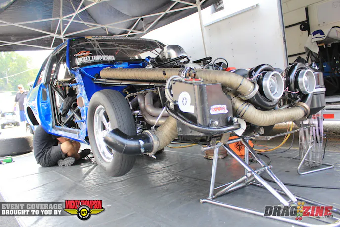 Mark Micke and Jason Carter make some adjustments to the suspension to better work with the hot track this afternoon in the second session of Outlaw Drag Radial qualifying, Micke currently sits ninth with a 4.62 @178 MPH.