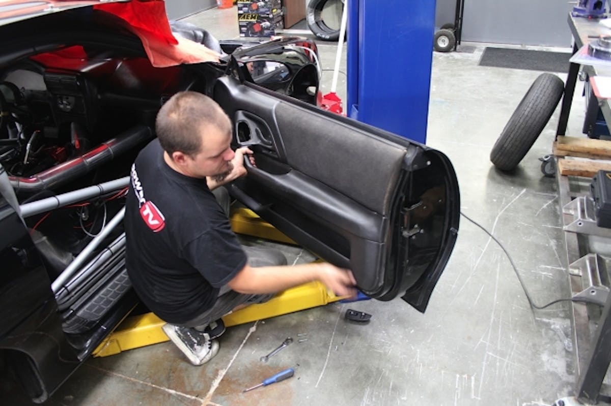 We begin with removal of the factory doors, hinges, and wiring harness, providing a fresh starting point for our new fiberglass doors.