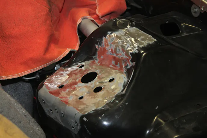 As you can see, we removed part of the original strut tower support, as we wouldn't be needing it. That left some holes in the inner fender, but the way we see it, that's a few grams of weight saved by not filling it in.