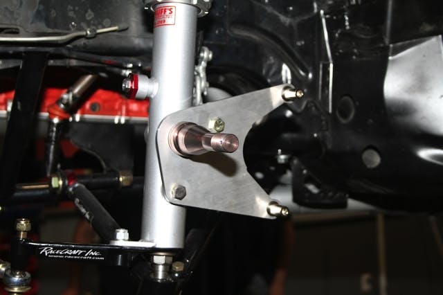 The struts come with the bracket for mounting the brake caliper, which, paired with a set of "hot dog" brackets creates the structural support for the caliper. With the rotor on the wheel, we can go ahead and place the wheel onto the awaiting spindle.