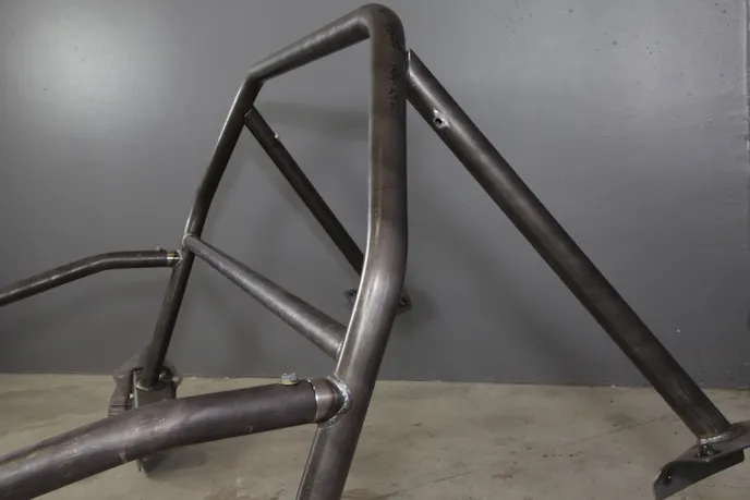 The rear support tubes slide over a spud that is welded to the main hoop of the roll bar. The rear bars must be initially bolted to the main hoop.