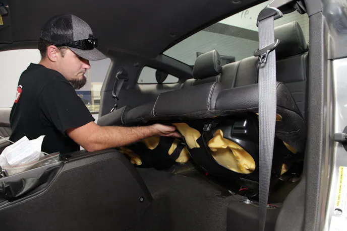 The front and rear seats were removed from our 2011 project car in order to make room during the roll bar installation.