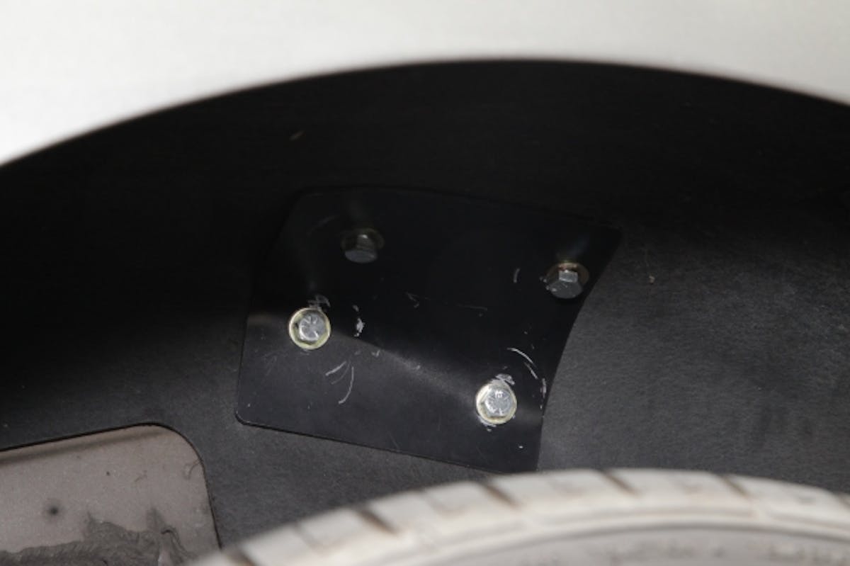 The rear support tube backing plates install in the rear wheel well of the car.  The bolts are installed from the wheel well area and tighten into a weld nut on the roll bar support tube.