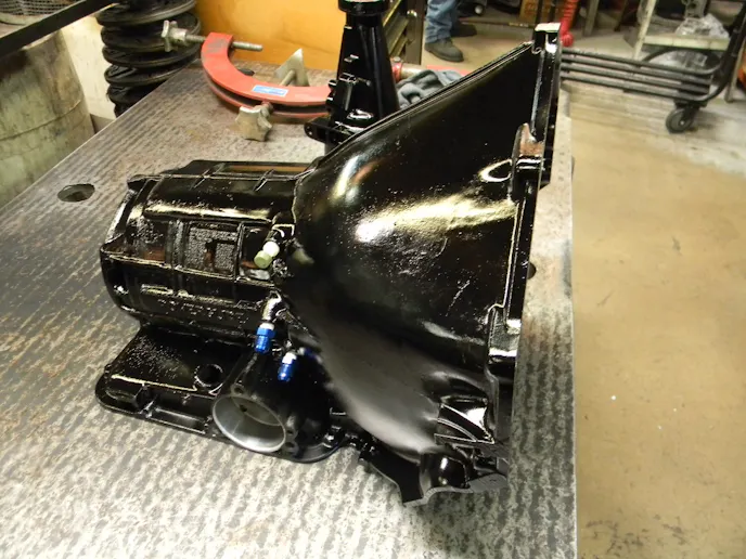 The Powerglide transmission build-up begins with a bare bones, OEM GM Powerglide transmission case. Hughes Performance cleans the cases in a chemical wash, blasts them with baking soda to clean away all the grime, and then paints them with a semi-gloss black paint, before moving on to installing the first components.