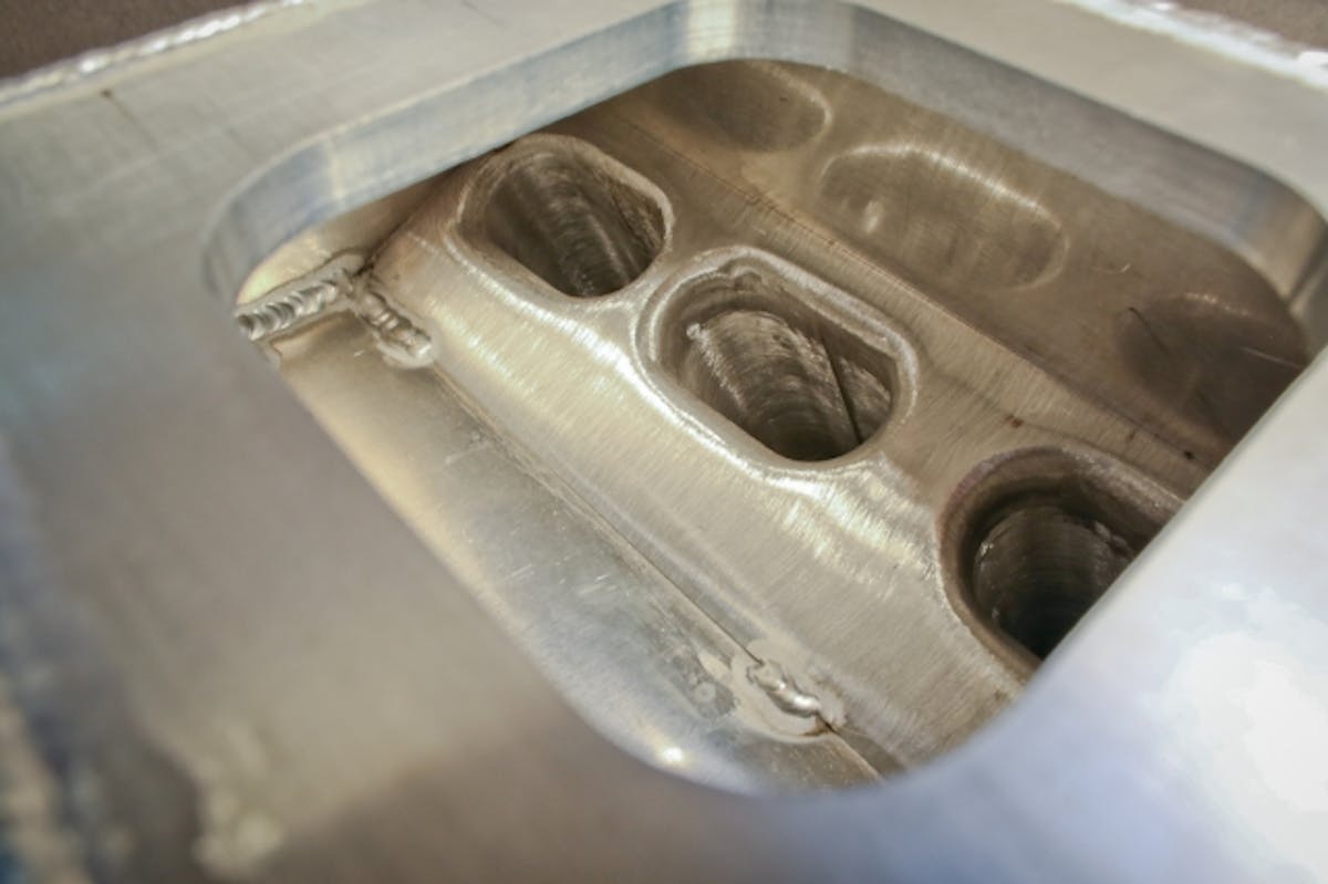 The inside of the plenum - you can see how the plenum floor is tucked up tight to the runner to prevent fuel puddling. Each runner was mocked up by hand prior to final welding. Runners are created from extrusion stock that has been hand-modified to create the final dimensions.