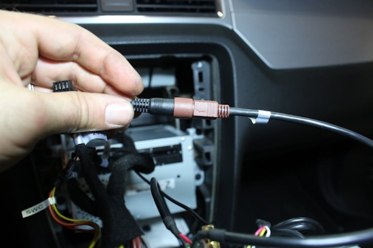 Plug in the supplied back-up camera harness, and reinstall the bezel.