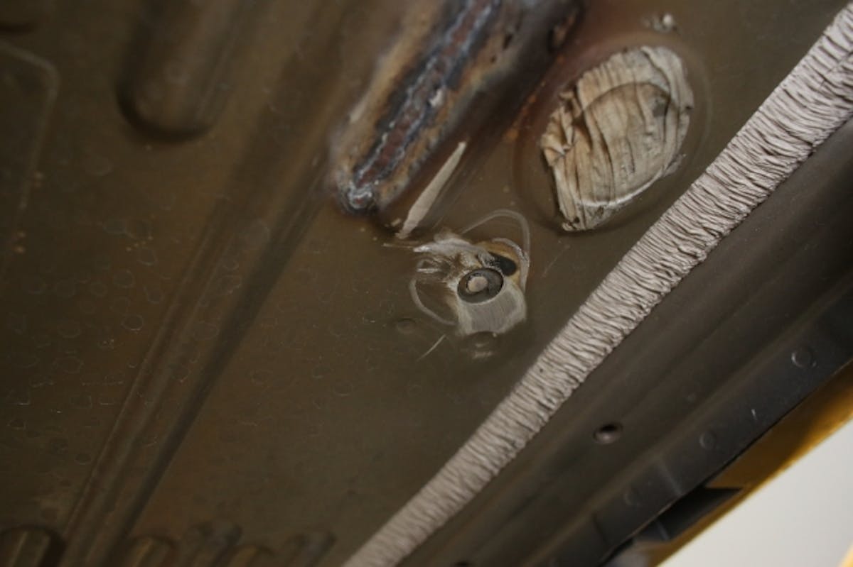 In order to provide clearance for our new subframe connectors, this stud from the fuel tank stone guard must be removed.