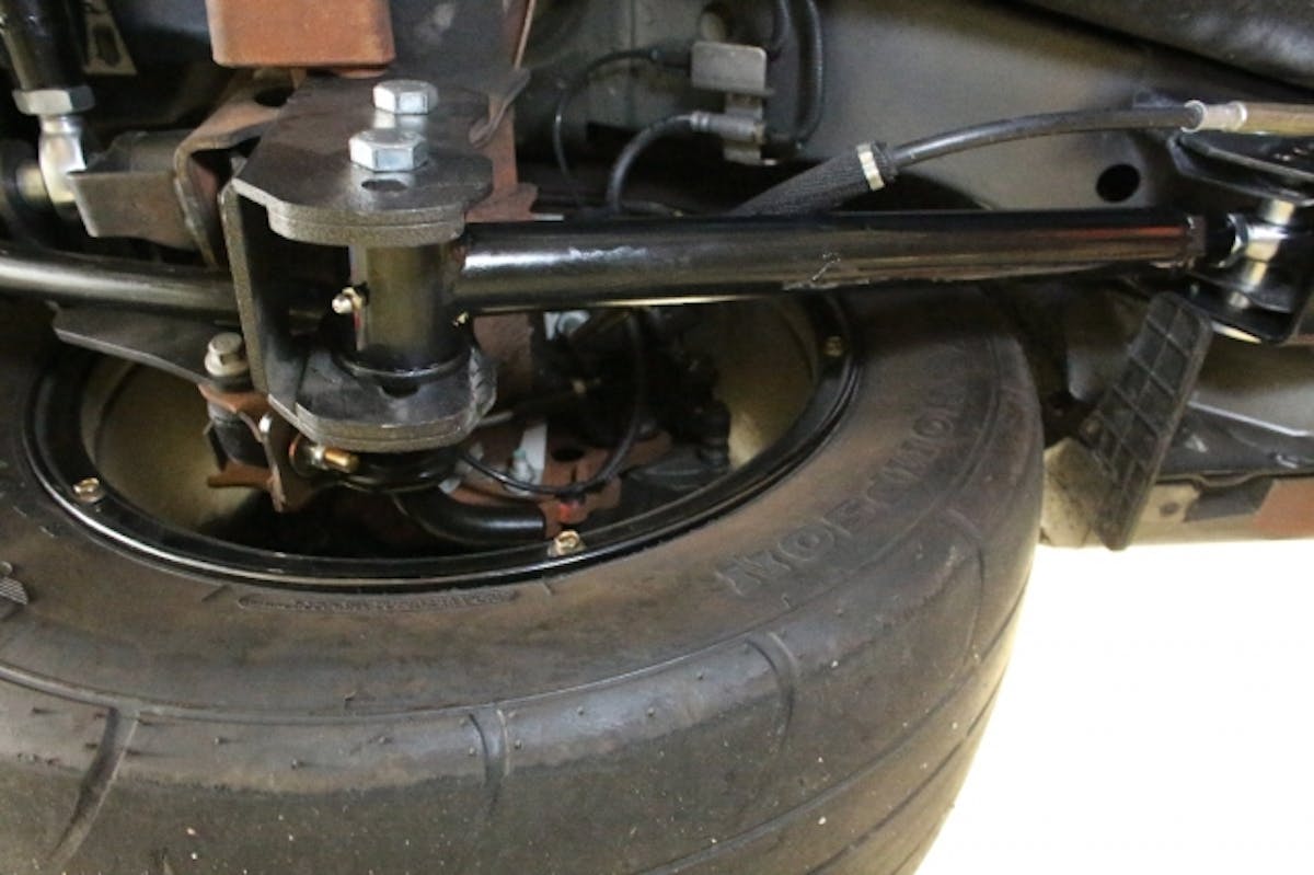 The factory lower control arms are made from stamped steel and have rubber bushings - great for reduction of noise and harshness, not so good for dragstrip launches. We copied their length for initial installation of the new arms, which have rod ends at the chassis mount. Spacers are included.