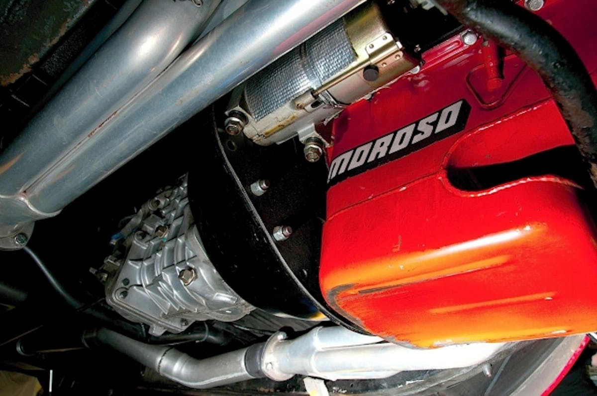 Looking under the car, one sees a Tremec TKO 500 transmission that is equipped with a Centerforce Dual Friction clutch system, encased with a Lakewood bell housing. A set of Earl Williams Headers connects to the 3-inch Flowmaster mufflers and a Moroso notched oil pan completed the scene.