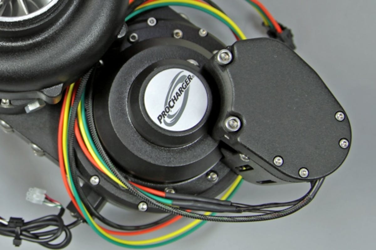 Contained within the bottom half of the supercharger assembly is the unique dry-hybrid belt drive that allows for programmable levles of boost.