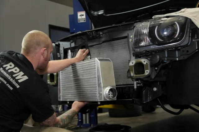 The massive intercooler assembly mounts behind the front bumper to provide cool air and is one of the hallmarks of a ProCharger system.