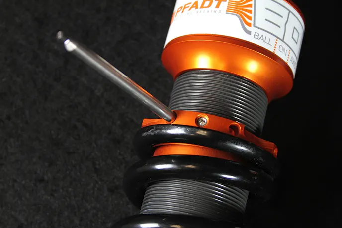 Rather than using the typical jam nut collar to secure the spring perch, Pfadt employs a threaded perch with an integral setscrew for simpler ride height adjustment.