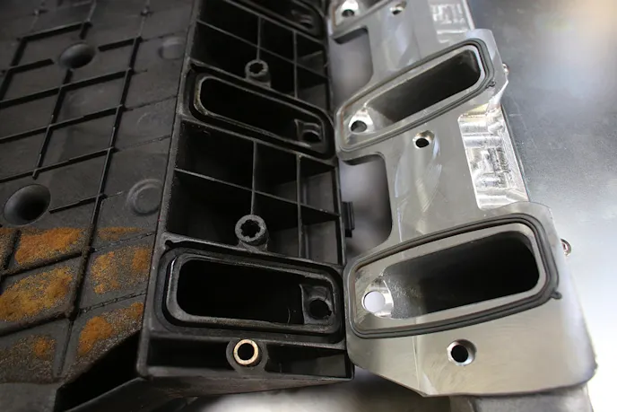 The SSI manifold uses factory-style O-ring seals. In this view, you can see how the aluminum construction offers an opportunity for porting that the thin-walled composite doesn't.