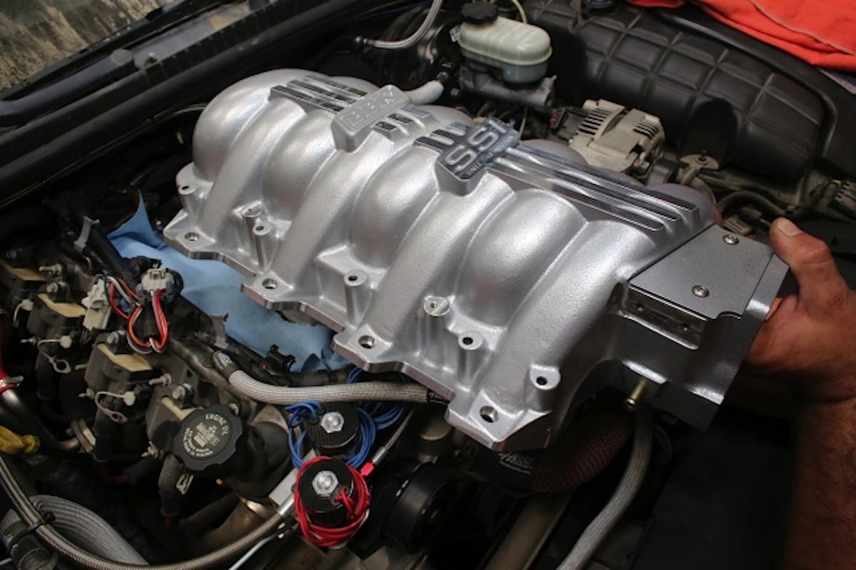 The SSI manifold is carefully introduced to its new home atop our LS1.