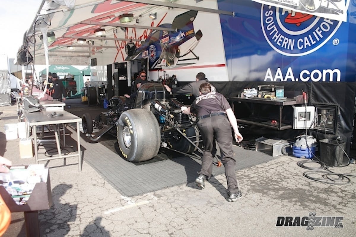 John Force's Funny, sans body,gets unloaded and pushed into the team's pit stall to get ready for this afternoon's qualifying sessions. 