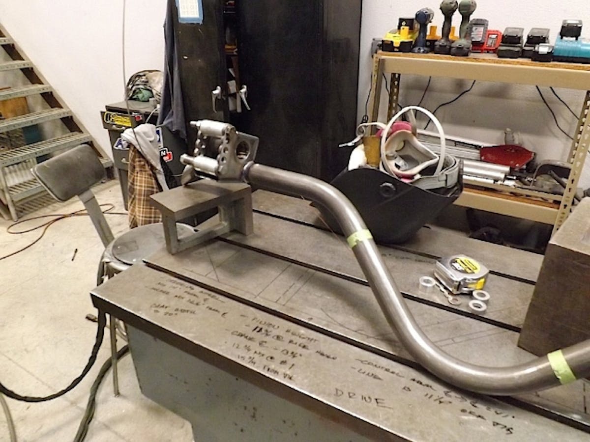 This is our new PMR main “#1″ bar which spans the width of the car and be incorporated both into the 25.3 chassis/cage but also serve as the primary mounting points for our rear lower control arms. This is setup in the exact stock location but allows upward and downward adjustability of the front suspension mounting point. It is also tied into the cage and 25.3 frame rails so that it will transfer all of the power from our engine properly into the chassis.