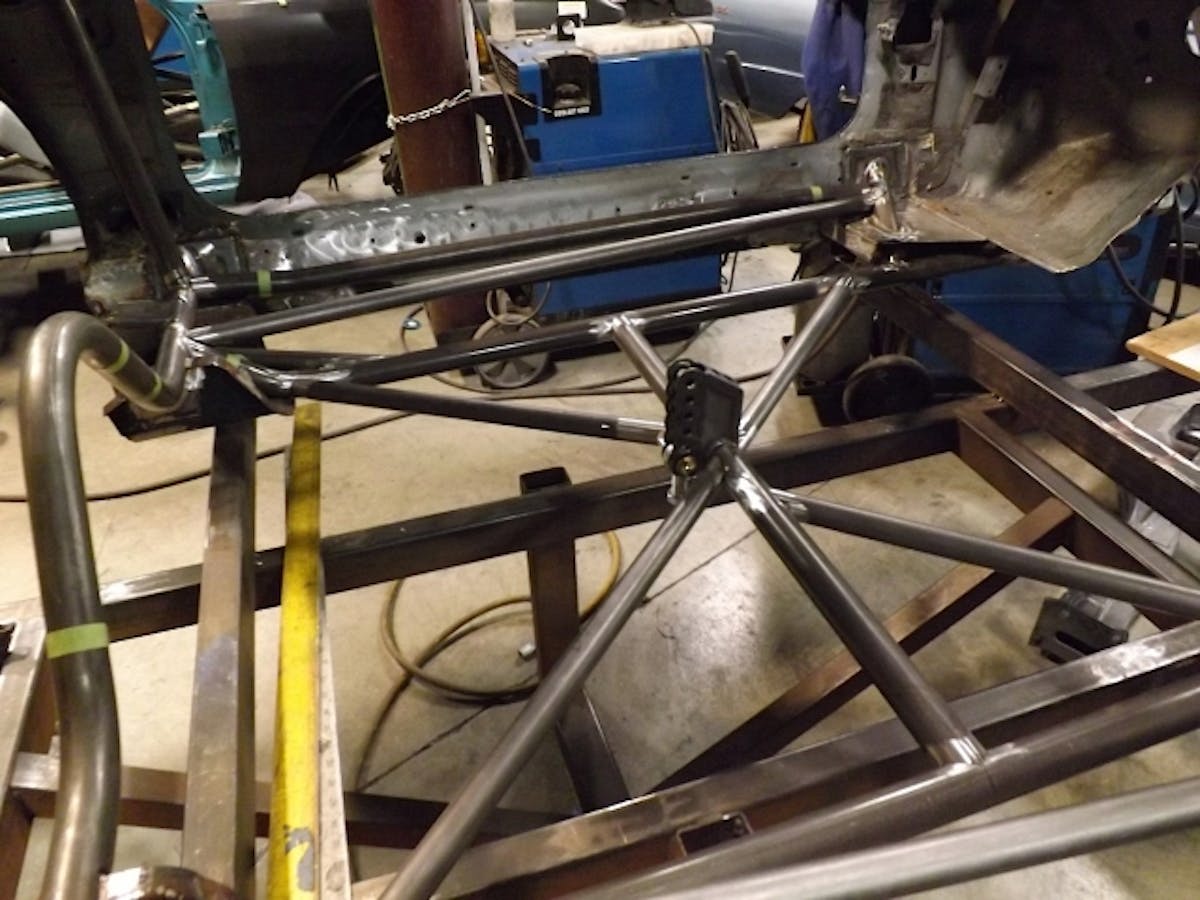 Here you can see the engineering PMR is putting into the chassis build. The frame rails (as part of the 25.3) actually tie directly into the front and rear frame rails of the stock Camaro chassis. The x-brace – also 25.3 required – ties into the torque arm. The rear control arm mounting locations tie into the stock frame, stock frame rails in rear, and to the 25.3 frame rails and #1 bar. It’s a tightly integrated package. You can see better now how the floorpan is going to reinstalled. The frame rails will go below the floorpan, the #1 bar and the rocker bars will go above.