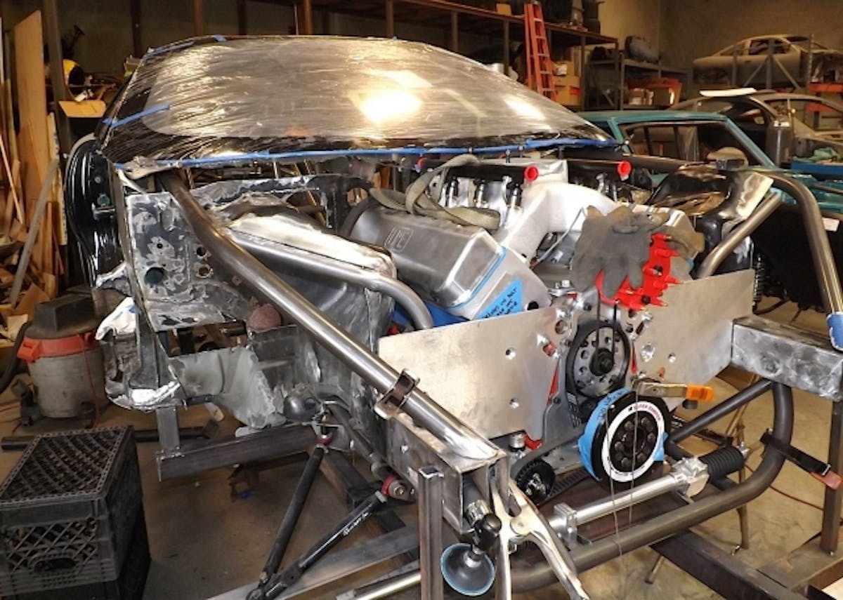 PMR did final mock up on the 400-inch LME LSX Engine with fitment on the front frame rails, motor plates, and other key areas. We needed to get an idea of where to trim the new Optic Armor window and what we needed to do for the induction trimming since the supercharger tubing would have to run straight in to the engine through the firewall.