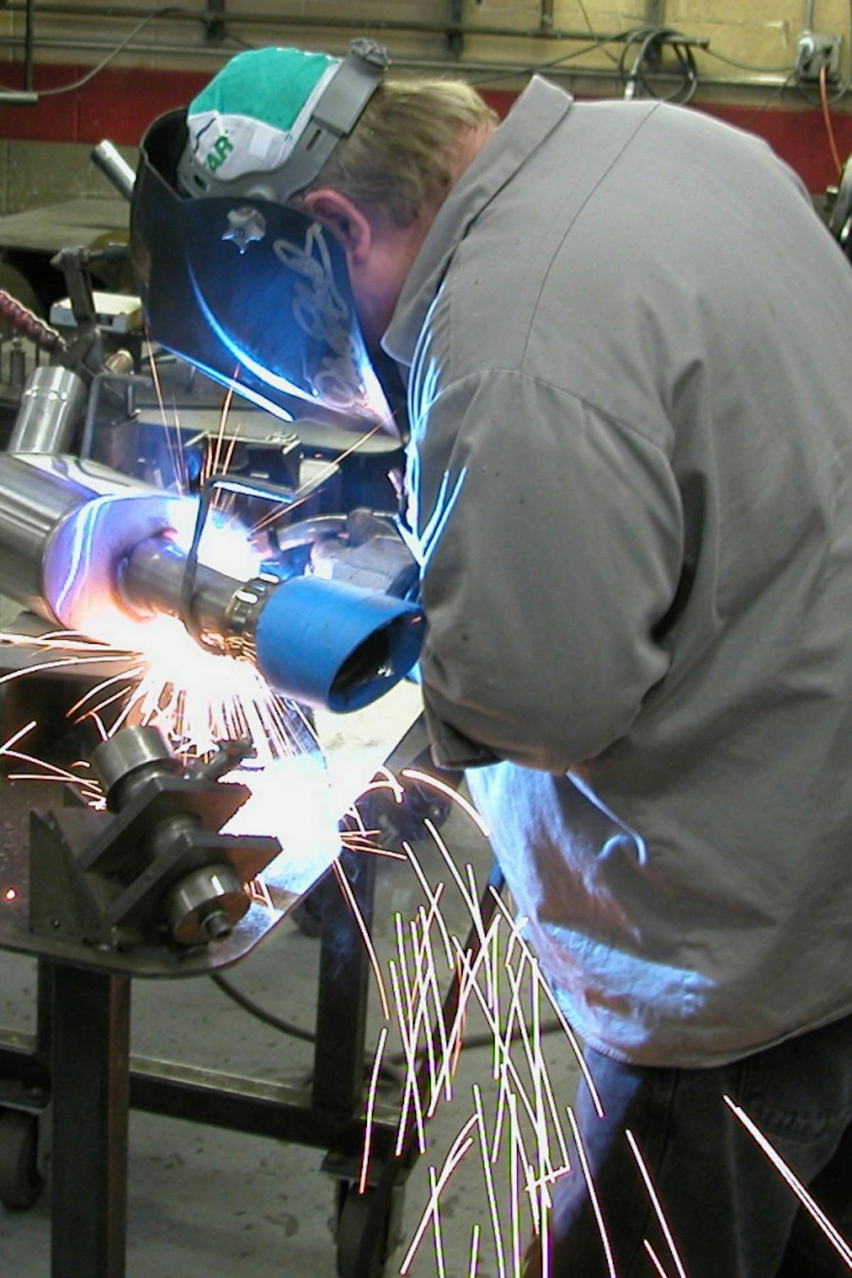 Here a CORSA Performance craftsman finishes up the welding on a muffler assembly. Both TIG and MIG welding are employed depending upon the situation.
