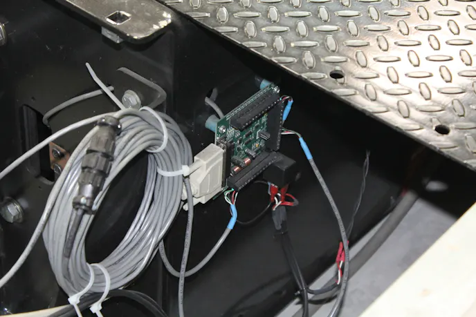 The breakout board is located on the dyno's frame near the roller.