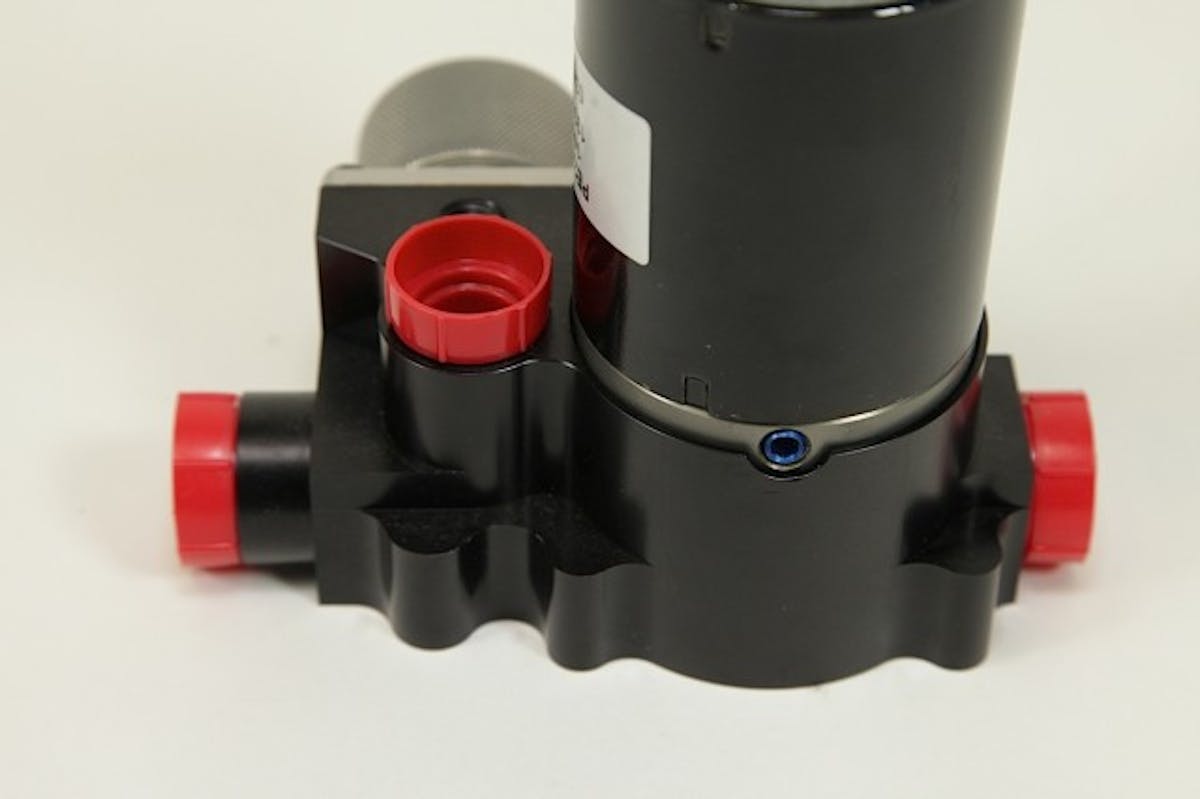 The vertical port on the back of the pump is the return, while the blue plug is for a seal drain, since this motor design is also used in Weldon’s aviation fuel pumps and the over-board drain is a requirement.