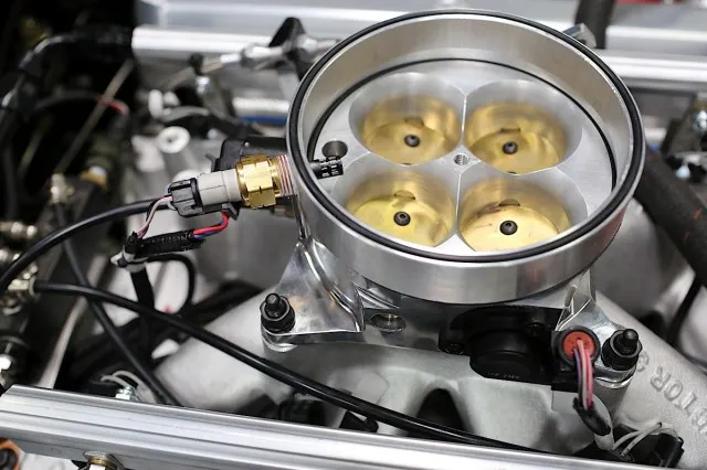 The throttle position sensor and IAT sensor are built into the throttle body's spacer ring.