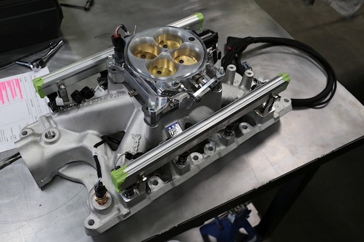 The XFI four-hole throttle body atop our Edelbrock intake manifold fits right in place of our old carburetor setup.