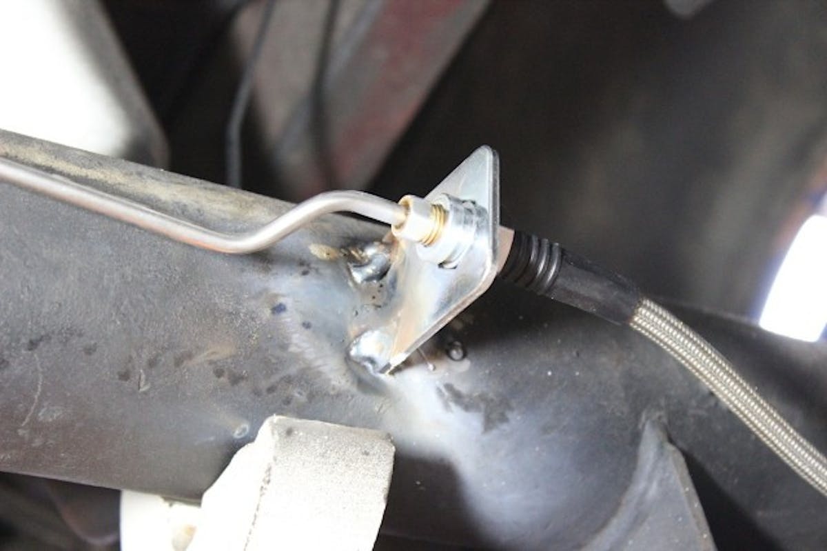 Welded tabs to hold the lines in place.