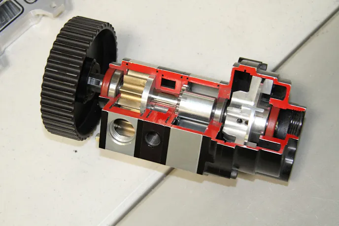 A cutaway of one of the company's pumps. In the front is the oil pressure feed pump with a pressure regulator just behind it, the middle portion makes up the scavenge sections and on the rear is an air oil separator.