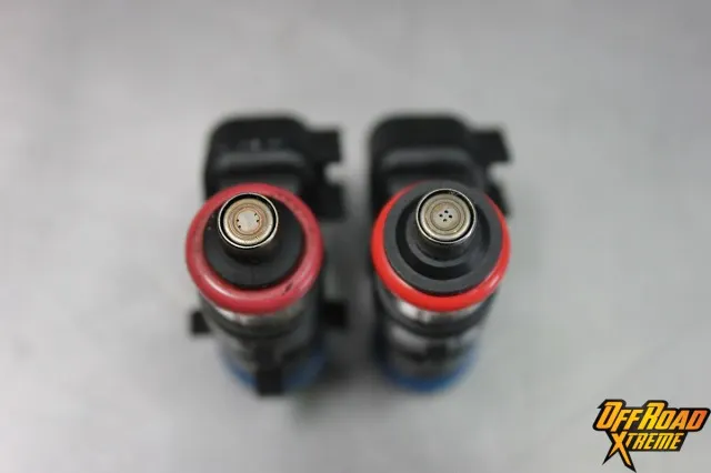 The stock injector (left) is compared with the ProCharger injector (right). Note the grouping of the jets on the ProCharger unit, as well as their slightly larger diameter.