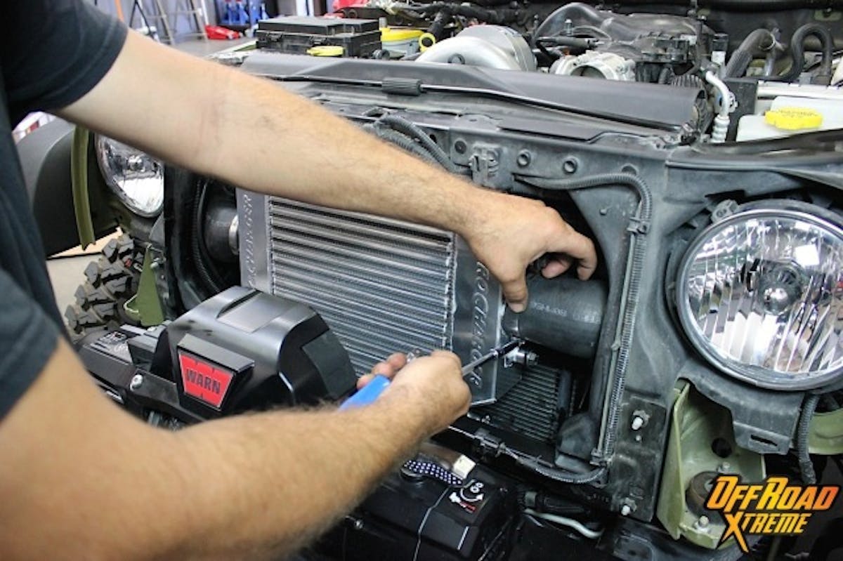 The intercooler is secured, and now the molded rubber hoses are clamped onto either side.