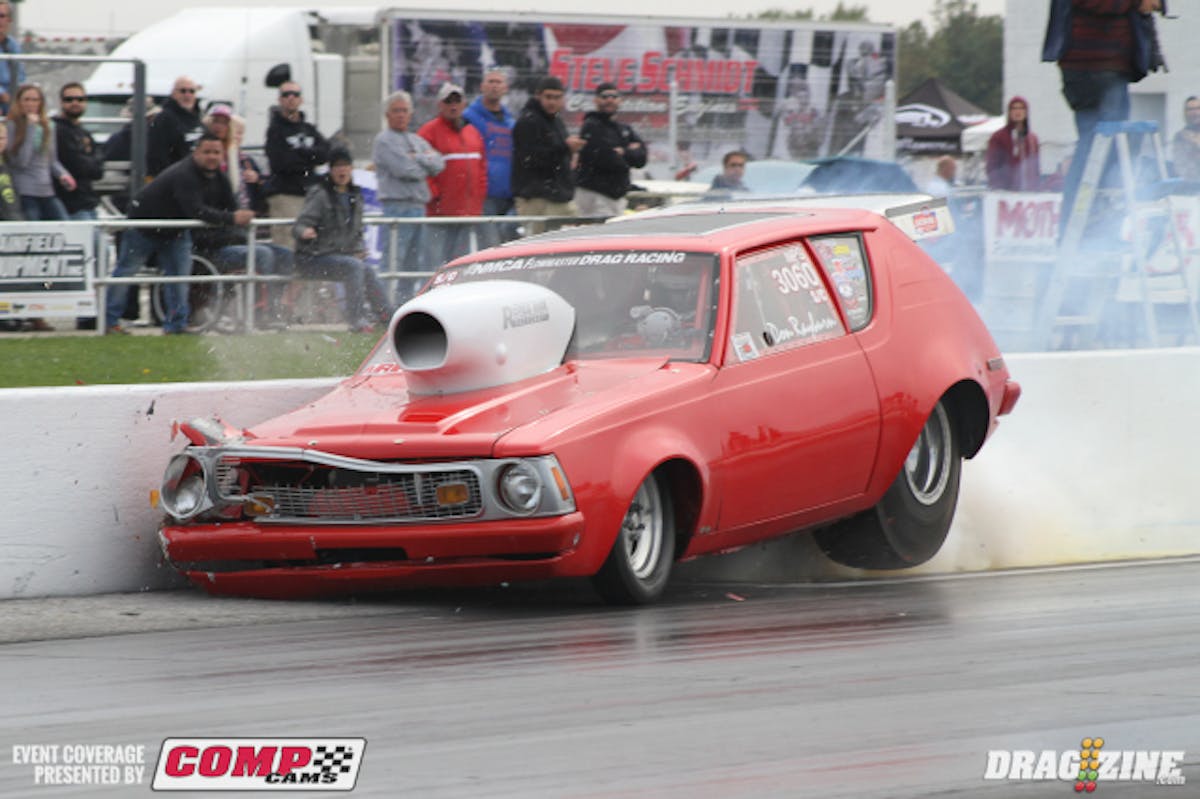 Nitrous Pro Street racer Don Rayburn went for one heck of a ride when his short wheelbase Gremlin took an abrupt turn just off the starting line. The impact hung the throttle, sending the car careening across the track where it rolled over on top of the wall and came to a rest on all fours.