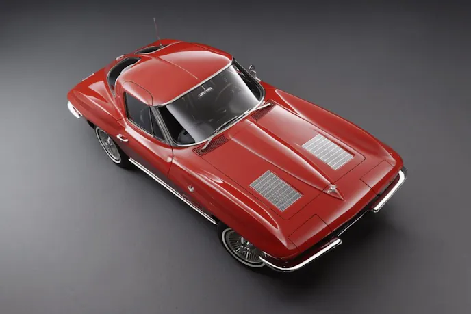 A fire engine red 1963 Chevrolet Corvette Sting Ray (C2) showing the distinctive non-functioning hood vents. (Business Insider)