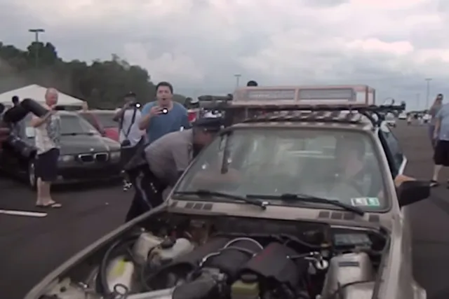 The police officer leans in to talk with the driver. Shenanigans ensue.