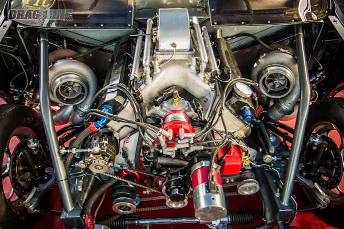 The engine, a 540 cubic inch big block Chevy paired with a set of mm turbos, produces ample horsepower to push this big four-door ride into the four-second range.
