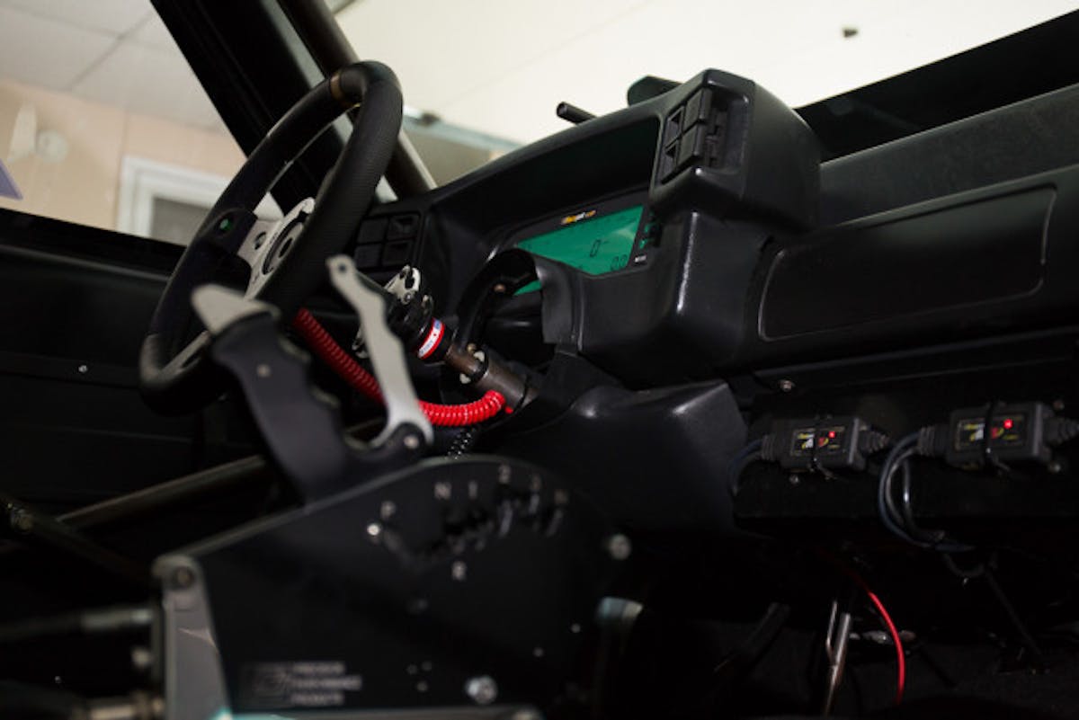 The interior of Hays' Mustang looks how a seven-second race car should look, with a 10-point cage, removable steering wheel, Racepak digital dash, and the like.